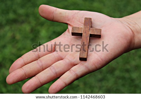 Christian cross banner,Cross in Human Hand Blurred nature background