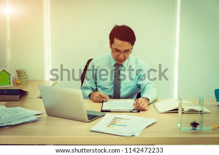 business man checking and sign the company report paper