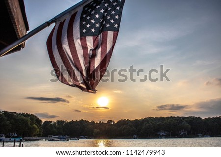A beautiful patriotic picture of an American flag back-grounded by a summer sunset.