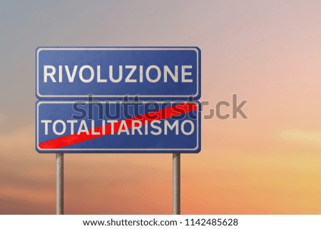 revolution and totalitarianism - blue traffic sign with inscriptions in italian