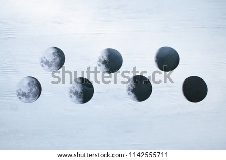 close up black and white photo pictures of different moon phases from new moon to full moon on textured white wooden background. astrology, Eclipse