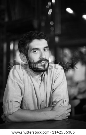 Portrait of a handsome man in a restaurant. Black and white photo