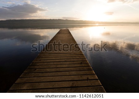 Sunrise with a boardwalk at Lake Sempach in Switzerland.