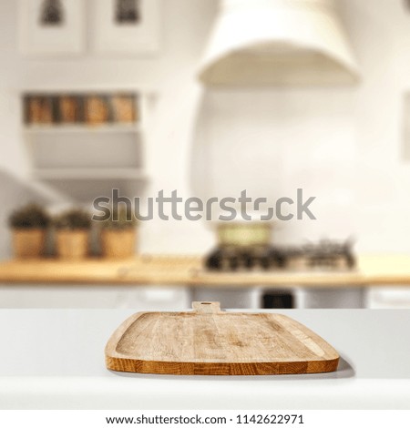 Blurred background of white kitchen furniture and kitchen desk top. Free space for your decoration. 