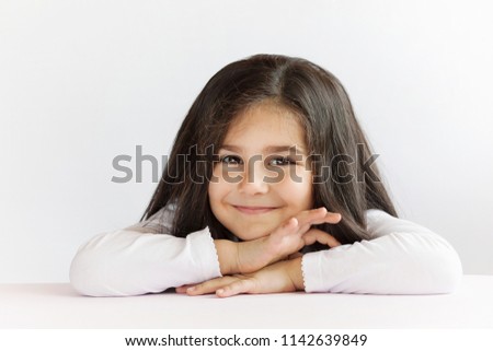 Portrait of cute thoughtful child girl. Dreaming people. Space for text.