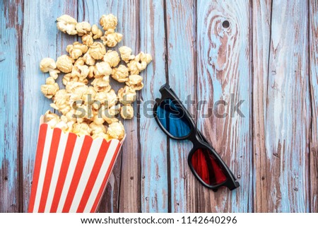 Cinema movie items, tickets, pop corn and 3d glasses on wooden background. Flat lay ,cinematography concept.