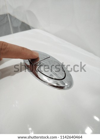 Pressing toilet bowl flush button