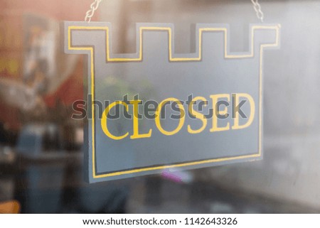 Close of a closed sign on the door glass.