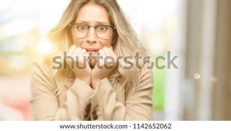 Young beautiful woman terrified and nervous expressing anxiety and panic gesture, overwhelmed