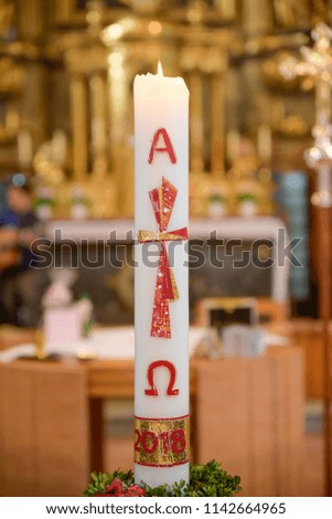 burning candle in the church at a wedding or christening