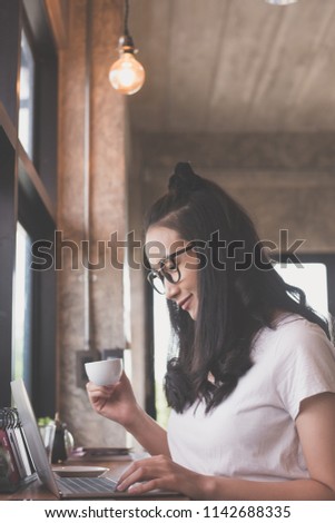 portrait beautiful woman. her working on laptop in coffee shop, freelance lifestyle.