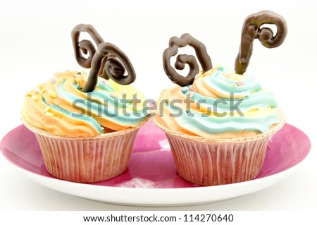 Cupcakes decorated with cream and chocolate colors
