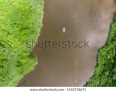 River rafting aerial shot. Сouple rowing an inflatable boat