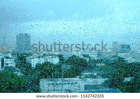 Water drops on window in city