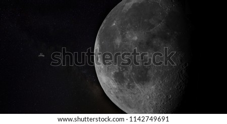 Moon close up with a satellite orbiting it. 