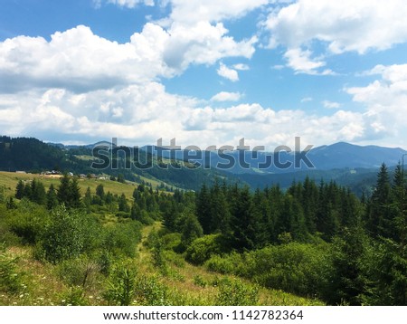 Karpaty is picturesque place mountains in Ukraine, and green grass around with blue sky
