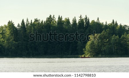 Two people in a boat going fishing, lake in Sweden