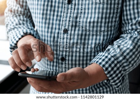 Close up of a man using mobile smart phone, online shopping concept.