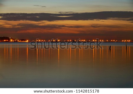 Long exposure shot of Lake view at Southern Thailand on sunset time background,Long exposure shot lake view with colored sky over lake on sunset time background.               