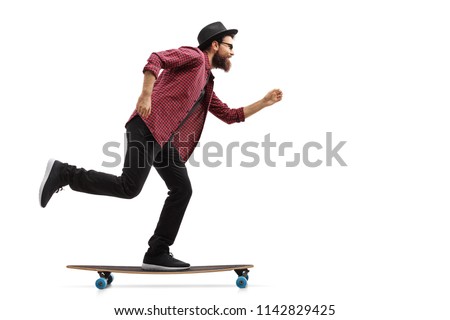 Full length profile shot of a hipster riding a longboard isolated on white background