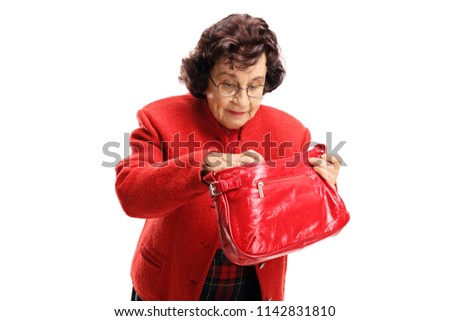 Senior lady searching through her bag isolated on white background