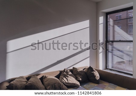 Sun is getting in through the window into living room. Close-up of apartment interior