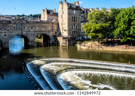 City of bath, England and it's famous landmark and tourist attraction of horse shoe shaped weir in the river Avon under the pulteney bridge.