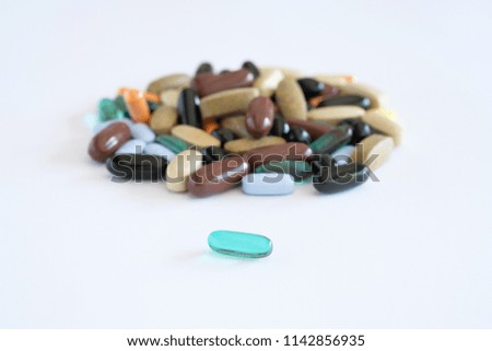 vitamins pills medications biological supplements pills multicolored round oval lie in a chaotic order on a white background