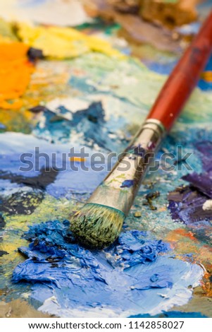 Shallow focus close-up of an artists paint palette and brush