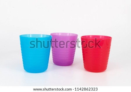 Colorful plastic cup on white background. Selective focus.