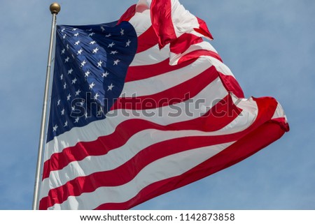 American flag flying stars and stripes forever.