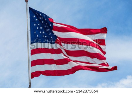 American flag flying stars and stripes forever.