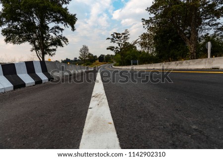 Roads in rural areas Traffic routes are white black and yellow Blue sky and beautiful white clouds background
Copy Space