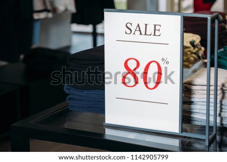 Sign in a clothing store with discount inscription SALE 80 % percent. Plate discount (sale)