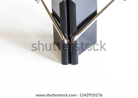 A black metalic stationery clip on a white list.