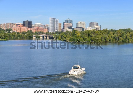 A boat sails toward Rosslyn in Potomac River - Washington DC United States of America