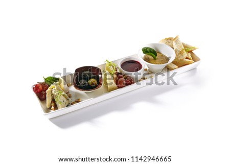 Wine Plate with Camambert, Mozzarella, Chicken Pate, Sweet Jam, Grapes, Nuts and Olive. Various Fruit, Meat and Cheese Snacks with Croutons Isolated on White Background