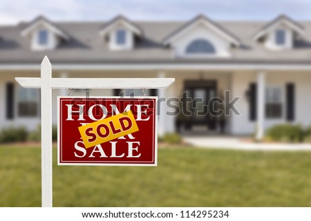 Sold Home For Sale Sign in Front of Beautiful New House.