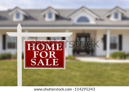 Home For Sale Real Estate Sign in Front of Beautiful New House.