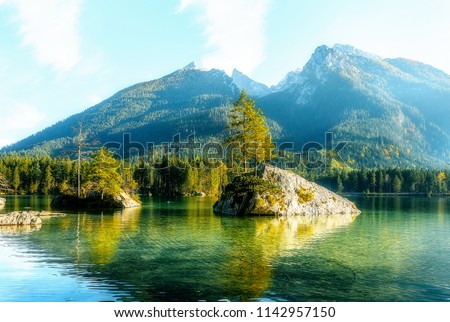 Impressively beautiful Fairy-tale mountain lake in Bavarian Alps. Breathtaking Scene. Amazing view of beautiful mountain landscape in Alpine under sunlit. Famous lake Hintersee. Nature Background