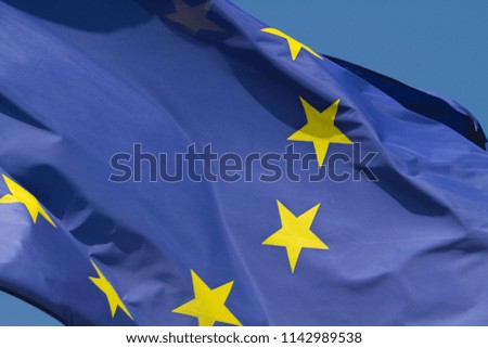 Blue and yellow flag of the European Union, blowing in the breeze.