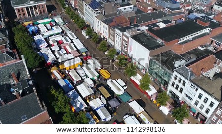 Aerial bird view photo of market located at shopping street a marketplace is a location where people regularly gather for the purchase and sale of provisions livestock and other goods