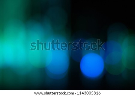 Abstract blurred colorful bokeh on dark background.
