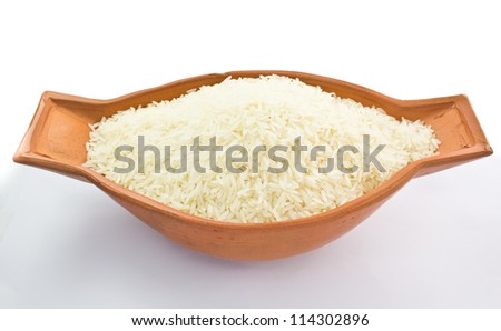 Uncooked rice in bowl on white background Royalty-Free Stock Photo #114302896
