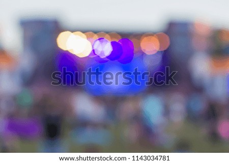 unfocused colorful blurred bokeh symmetry main stage facade in summer bright day time on one music festival