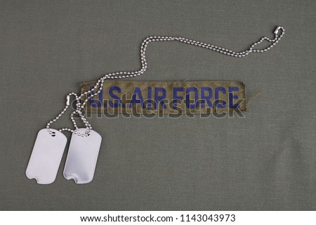 U.S. AIR FORCE Branch Tape with dog tags on olive green uniform background