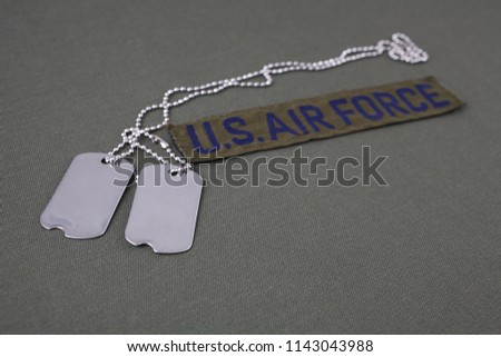 U.S. AIR FORCE Branch Tape with dog tags on olive green uniform background