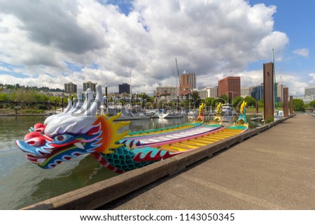 Dragon Boats moored along Willamette River in downtown waterfront marina in Portland Oregon