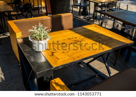 Wooden table with armchairs in a cafe