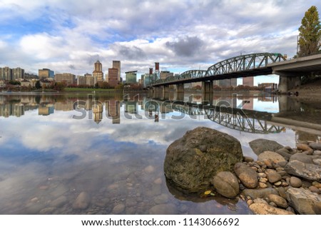 City of Portland Oregon skyline by Hawthorne Bridge reflected on Willamette River
